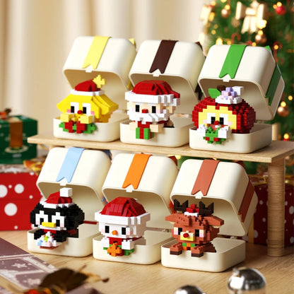 Set of Christmas-themed building block figures in gift box packaging on a wooden stand.